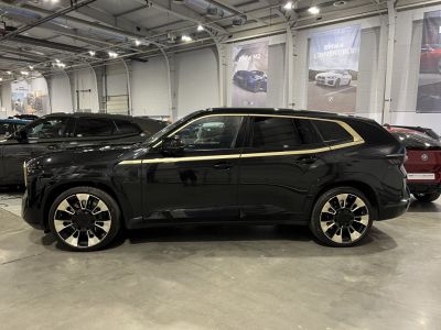 Black SUV with modern alloy wheels and gold trim lines side view