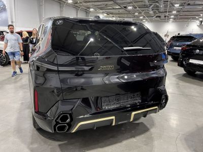 Black SUV rear with dual hexagonal exhausts and tinted window