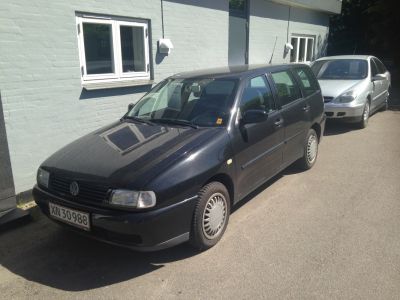 Front and side view of a compact black estate car with practical design.