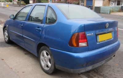 Rear and side profile with tail lights, bumper, and sedan body.