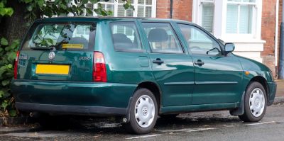 Rear side view of green mid-90s wagon with classic styling