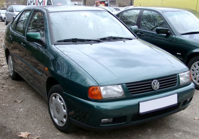 Green compact hatchback front with rectangular headlights.