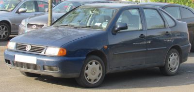 Front side view of a compact hatchback with rounded body and rectangular headlights.