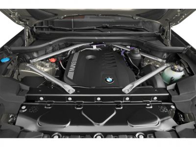 Engine bay with BMW-branded engine cover and structural support rods