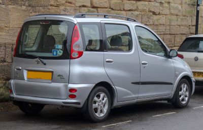 Silver compact MPV with high roof and large rear window.