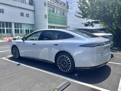 Aerodynamic white sedan with flush door handles and stylish alloy wheels