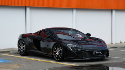 Black luxury sports coupe with aerodynamic body and performance wheels