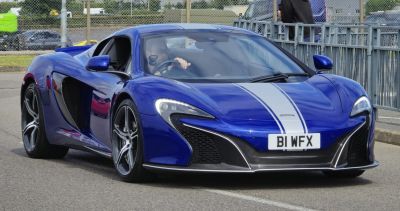 Blue sports car front with racing stripes and aerodynamic design