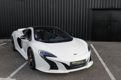 White sports coupe with aerodynamic design and carbon fiber accents