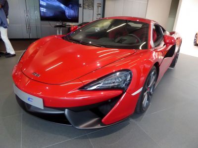 Red sports car front view with aerodynamic design and sleek headlights