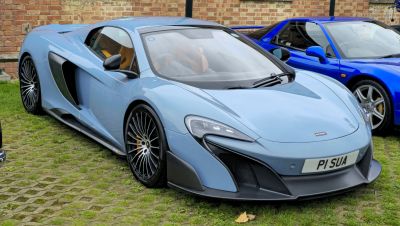 Aerodynamic coupe with aggressive front intake and multi-spoke wheels