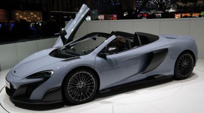 Convertible sports car with dihedral door open and aerodynamic styling