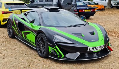 Green and black race car with aerodynamic enhancements and racing livery