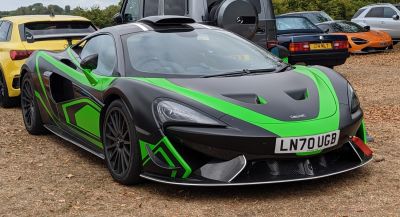 Black and green racing livery with aerodynamic front and carbon fiber details