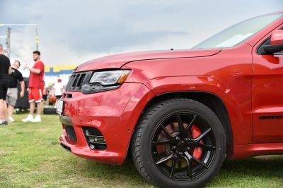 Red SUV front side with black alloy wheel and red brake caliper