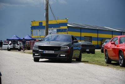 Front view of a 2015 Dodge Charger with prominent grille and LED daytime running lights
