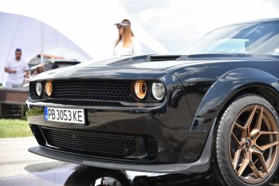 Front fascia and bronze alloy wheels of a muscle car.