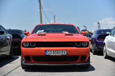 Front view of aggressive muscle car with dual round headlights and R/T grille.