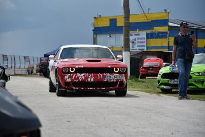 Red muscle car front with halo headlights and white splatter paint