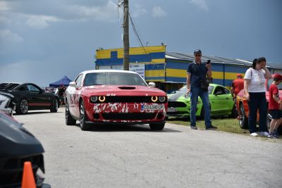 Front view of muscle car with halo headlights and hood scoop