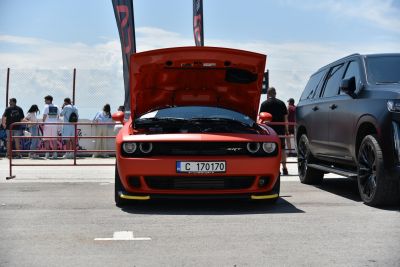 Muscle car front view with open hood and engine visible