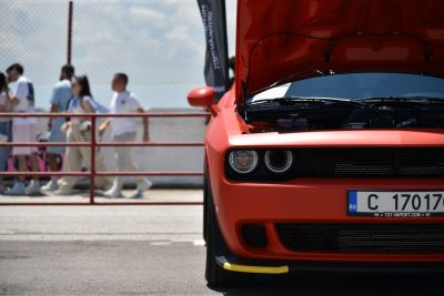 Front view of 2014 facelift muscle car with open hood and round headlights