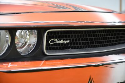 Close-up of front grille with Challenger badge and headlight
