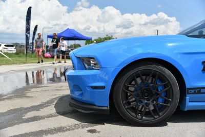 Blue front side and black alloy wheel with brake caliper