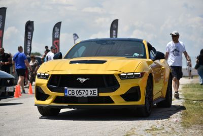 Yellow car front view with aggressive grille and modern LED headlights