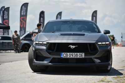 Front view of a sporty car with aggressive grill and sleek headlights
