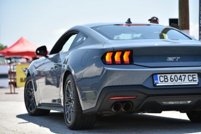 Rear view featuring triple vertical taillights and dual exhaust pipes