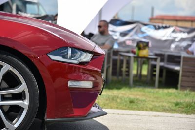 Close-up of headlight and wheel on red car front left side