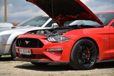 Front view of Mustang with open hood and detailed headlight