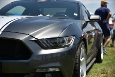 Close-up of front headlight and hood with racing stripes