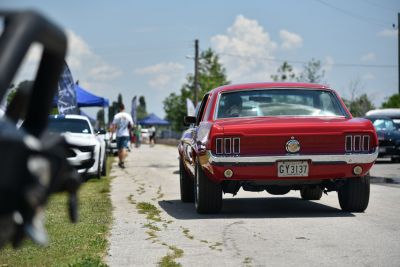 Red vintage Mustang rear with triple tail lights and classic design