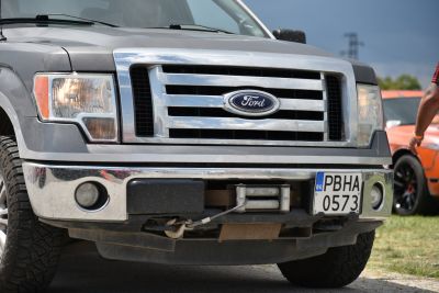Pickup truck front grille with integrated winch and headlights