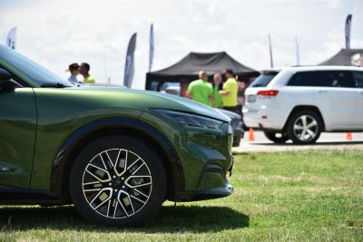 Close-up of front wheel and headlight on a sleek electric SUV