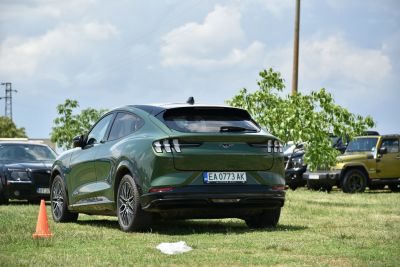 Rear view of an electric SUV with distinct taillights and aerodynamic shape.