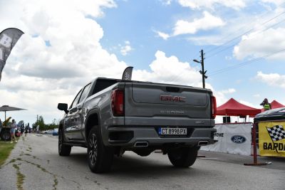 Rear view of a pickup truck showing tailgate, exhaust, and dual rear lights