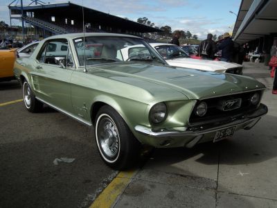 Classic vintage Mustang front grille and round headlights view.