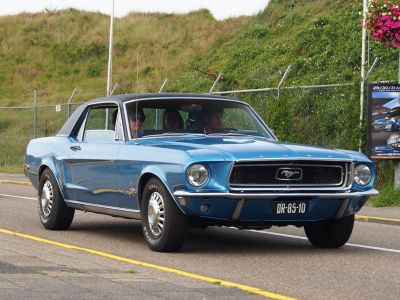 Front view of blue 1967 hardtop coupe with chrome grille and round headlights