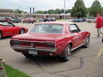 Rear view of vintage Mustang with iconic triple tail lights and chrome bumper