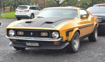 Yellow muscle coupe with black hood scoops and iconic front grille