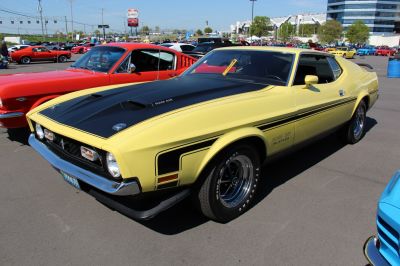 Muscle car with ram air hood and racing stripes.