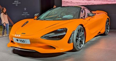 Orange sports coupe front fascia with black wheels and carbon fiber accents
