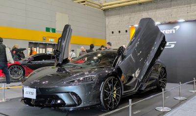 Sports car with butterfly doors and aerodynamic sleek design