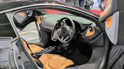 Touring cockpit and tan leather seats in luxury car interior
