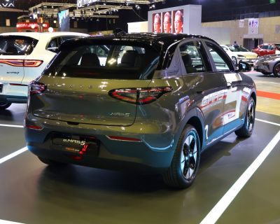 Rear view of an electric SUV with distinctive taillights and side decals