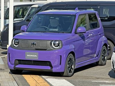 Compact purple vehicle with round LED headlights and four doors