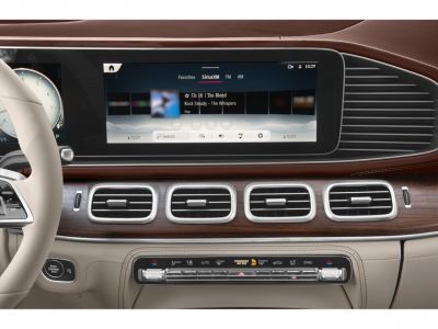 Digital dashboard and wooden trim air vents in luxury SUV interior